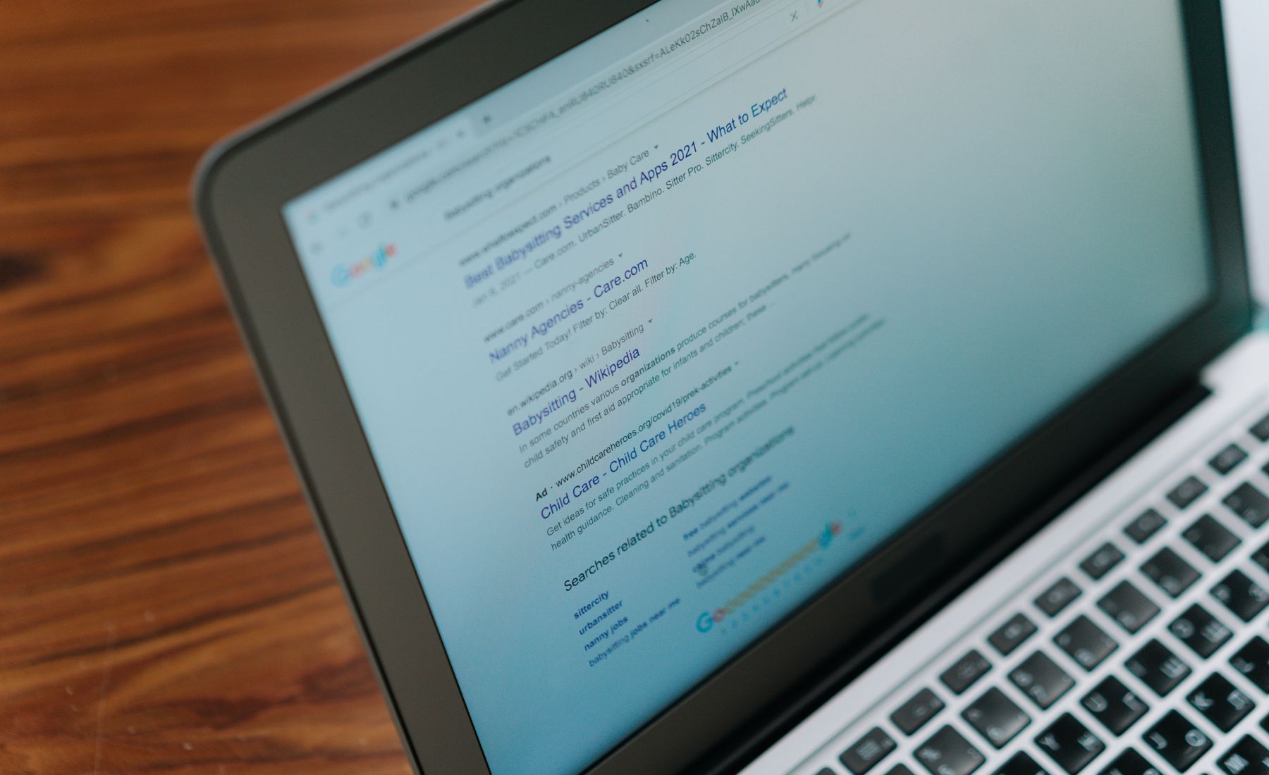 Google search results displayed on a laptop, representing higher keyword rankings